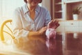 Eldely woman hands putting coin to piggy bank for retirement,Saving money concept,Saving money concept