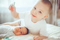 Cute little baby with elder brother lying on bed at home Royalty Free Stock Photo