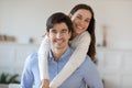 Elder brother student piggybacking teenage sister posing for cute picture