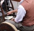 Elder carder while carding wool or cotton with old wooden machin