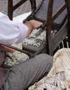 Elder carder while carding wool or cotton with old wooden machin