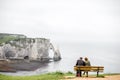 Elder couple enjoying view on the rocky coastline