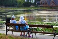 Elder couple outdoor enjoying great view over the lake full of water lilies.