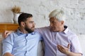 Elder father giving support and advice to grownup son Royalty Free Stock Photo