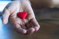 Elder Female hands giving little red heart