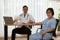 Elder female patient consult with smart orthopedic doctor Royalty Free Stock Photo