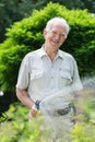 Elder gardener with hosepipe Royalty Free Stock Photo
