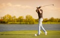 Elder golf player teeing off. Royalty Free Stock Photo