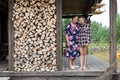 Elder grandmother and young granddaughter standing on the veranda of summer house, next to the woodpile, full-length portrait, Royalty Free Stock Photo