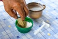 Elder hands using shaving brush with blade on blue table