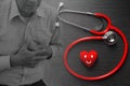 Elder with Heart attack chest pain overlay with stethoscope and smile red heart symbol for love care health concept