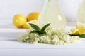 Elder lemonade - healthy and refreshing summer drink. Close up of homemade elderflower syrup in a bottle with elderflowers. Summer