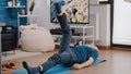 Elder man laying on yoga mat and training muscles Royalty Free Stock Photo