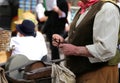 Elder man while sharpens knife in grindstone Royalty Free Stock Photo