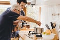 Elder seasoning soup with natural ingredient cooking with young man for stay at home activity family together Royalty Free Stock Photo