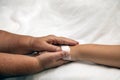 Elder senior hold woman patient hand sleeping on bed in hospital room Royalty Free Stock Photo