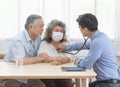 Elder senior old asian couple meeting  specialist professional caucasian doctor visit at home consultant two retirement patient Royalty Free Stock Photo