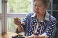 Elder senoir eating blueberry cheese cake at cafe. asian elderly