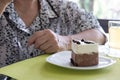 Elder senoir eating chocolate mousse cake at cafe. elderly woman