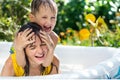 The elder sister and younger brother are indulging in an inflatable pool in the garden,