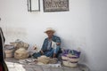 Elder street vendor selling handmade souvenirs