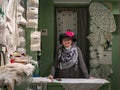 Elder stylish woman stands at the counter in a lace shop in Venice, Italy