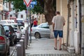 Elder with walking stick on village street, exercise