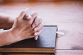 Elder woman hands folded in prayer on a Holy Bible Royalty Free Stock Photo