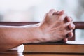 Elder woman hands folded in prayer on a Holy Bible Royalty Free Stock Photo