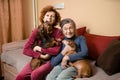 Elder woman and her adult daughter together with two dachshund dogs on sofa indoors spend time happily, portrait. Theme of mother Royalty Free Stock Photo