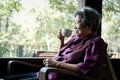 Elder woman holding tea cup on terrace. elderly female relaxing Royalty Free Stock Photo