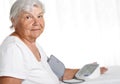 Elder woman measuring blood pressure with automatic manometer Royalty Free Stock Photo