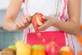 Elder woman peeling apples in kitchen Royalty Free Stock Photo