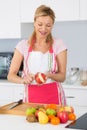 Elder woman peeling apples in kitchen Royalty Free Stock Photo