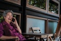 elder woman talk on mobile phone on terrace. elderly female speaking on smartphone on patio. senior have phone conversation at ho Royalty Free Stock Photo