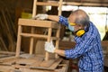 Elder worker wood woodcraft retire hobby for good retirement, Asian male mature professional master of making wooden furniture