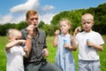 Elder and younger brothers blowing soap bubbles Royalty Free Stock Photo