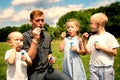 Elder and younger brothers blowing soap bubbles Royalty Free Stock Photo