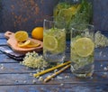 Elderberry flowers and lemon drink. Refreshing healthy summer juice. Glass of elderflower lemonade on wooden rustic board. Alterna