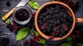 Elderberry jam nestled in a glass jar on a wooden table Royalty Free Stock Photo