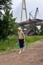 Elderling, who lives in house under bridge, goes for water.