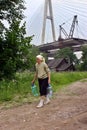 Elderling, who lives in house under bridge, goes for water. Royalty Free Stock Photo