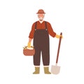 Elderly agrarian, old farmer in work dungarees standing with shovel, vegetable basket. Retired man, seasonal harvest Royalty Free Stock Photo