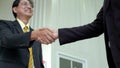 Elderly Asian businessman shake hand, agreed to cooperate business