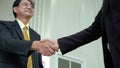 Elderly Asian businessman shake hand, agreed to cooperate business