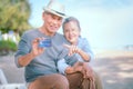 Elderly Asian couple holding a credit card with a smile Health insurance for the elderly, retirees Royalty Free Stock Photo