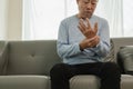 An elderly Asian male patient suffers from pain and numbness in his hand from rheumatoid arthritis. Royalty Free Stock Photo