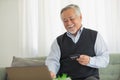 Elderly Asian man using credit card and laptop in online shopping Royalty Free Stock Photo