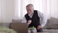 Elderly Asian man video conferent online with teblet at home