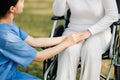 Elderly asian senior woman on wheelchair with Asian careful caregiver. Nursing home hospital garden concept. in sun light Royalty Free Stock Photo